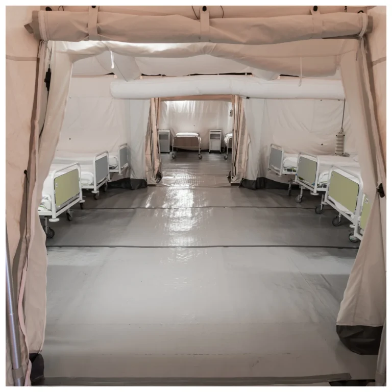Empty field hospital tent with patient beds